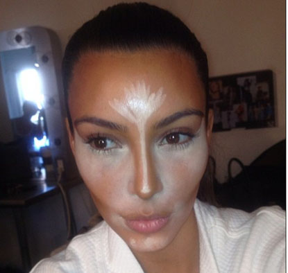 Kim Kardashian showing where to apply highlight